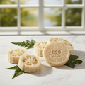 Natural loofah scrub pad set of 4 on white marble with green leaves